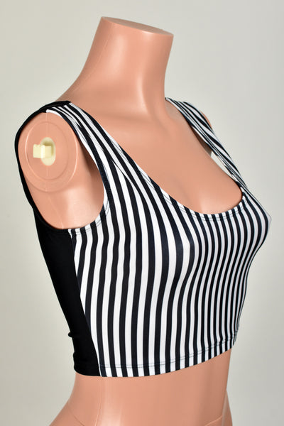 Mannequin wearing cropped spandex tank top. Front of top is scoop neck with 1/4 inch wide black and white vertical stripes. Back is solid black spandex.