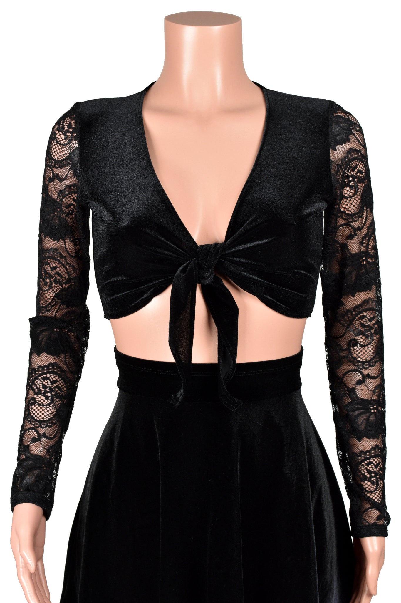 Mannequin wearing a black velvet tie-front sweater with sheer lace sleeves with a black velvet flared skater skirt
