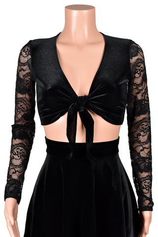 Mannequin wearing a black velvet tie-front sweater with sheer lace sleeves with a black velvet flared skater skirt